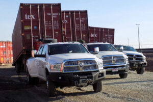 Used shipping container delivery fleet of trucks